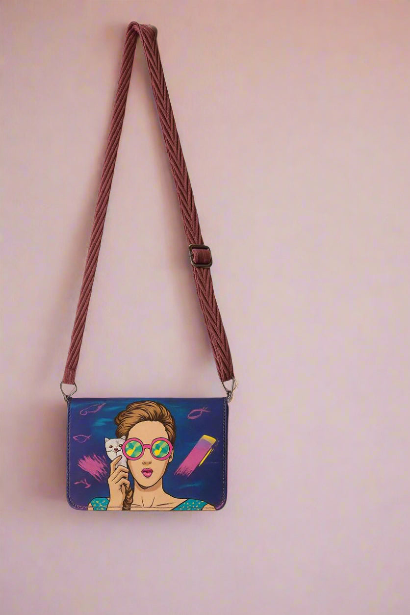 Crossbody bag with a colorful design of a woman holding a cat on a plain background